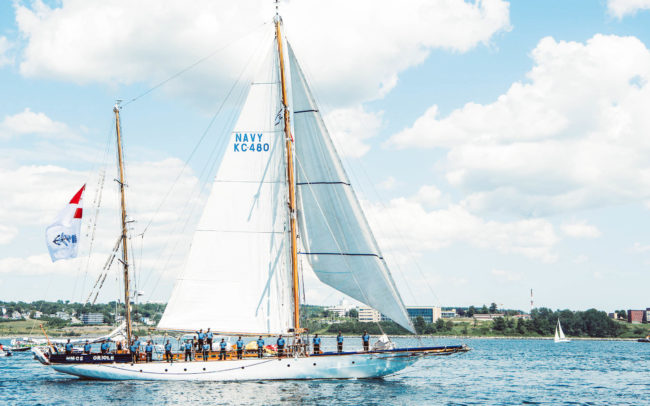 Elegant sailboat with a dozen sailors on board